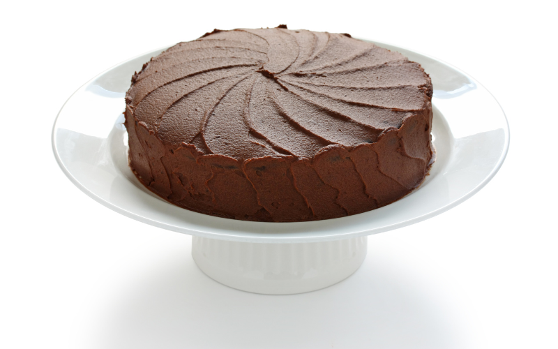 Devil's Food Cake pictured on top of a white presentation platter for world baking day