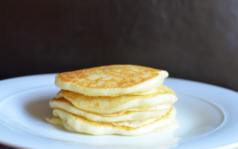 A stack of potato starch pancakes on a plain white plate.